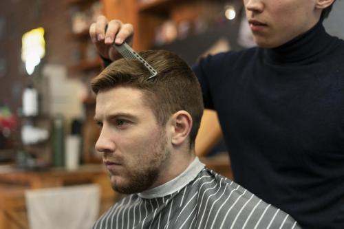 close-up-hairdresser-holding-comb