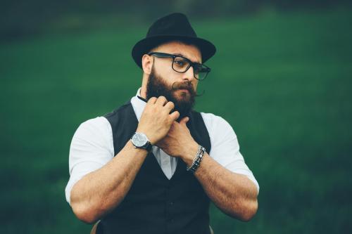 bearded man preparing to shave in the field